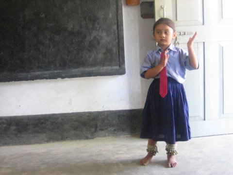 girl in schoo uniform in front of blackboard